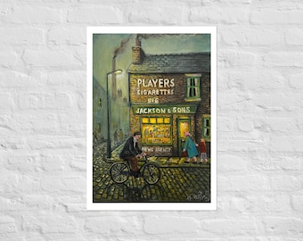 May include: A print of a painting depicting a brick building labeled Players Cigarettes No 6 Jackson & Sons News Agents. A person rides a bicycle on a cobblestone street in front of the shop, while two other figures walk near the entrance.
