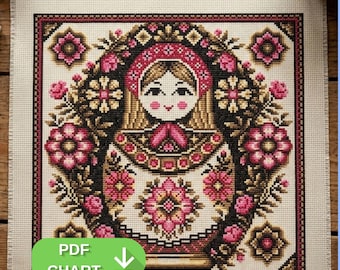 May include: A cross-stitch pattern featuring a Matryoshka doll design, surrounded by floral elements in pink, black, and gold. The doll has a red headscarf and a detailed floral pattern on her dress. The words "PDF CHART" are displayed in a green oval.