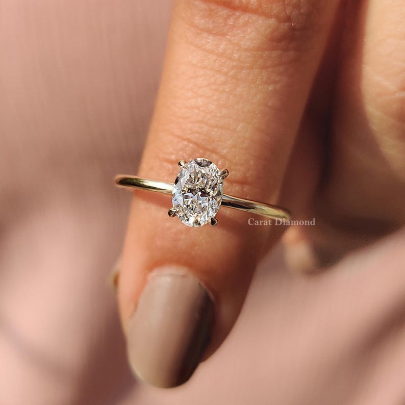 Oval Cut Diamond Ring set in a classic yellow gold band with a 4-claw prong setting.