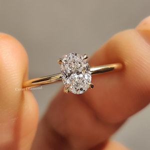 Handmade Jewelry featuring an exquisite oval diamond in a timeless design.