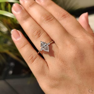 Proposal ring featuring a marquise diamond with pear side accents in a classic setting.
