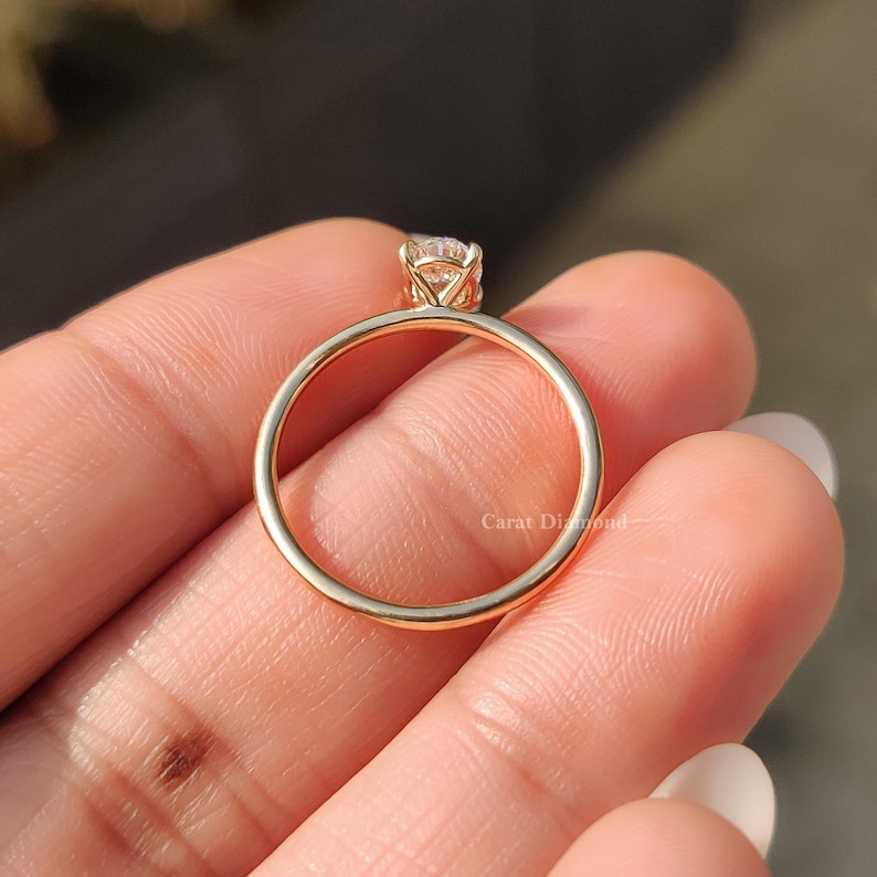 Yellow Gold Engagement Ring with a dazzling oval-cut diamond centerpiece.