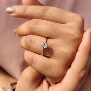 Carat Diamonds Ring with a radiant oval-cut stone in a yellow gold setting.