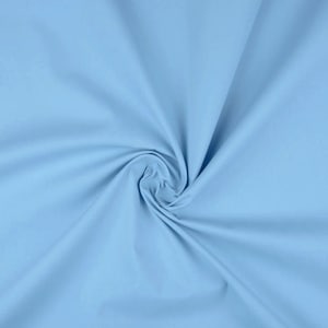May include: A close-up of a light blue fabric, showing the texture and drape of the material.