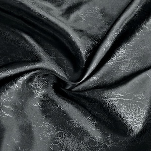 May include: Black fabric with a textured, crinkled surface. The fabric has a subtle sheen and a soft, drapey feel.