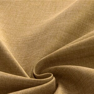 May include: Close-up of a brown fabric with a textured weave. The fabric is folded and has a soft, natural look.