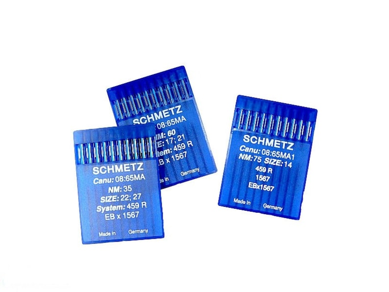 May include: Three blue plastic packages of sewing machine needles. Each package has the brand name "SCHMETZ" printed on it, along with the needle size and other information.