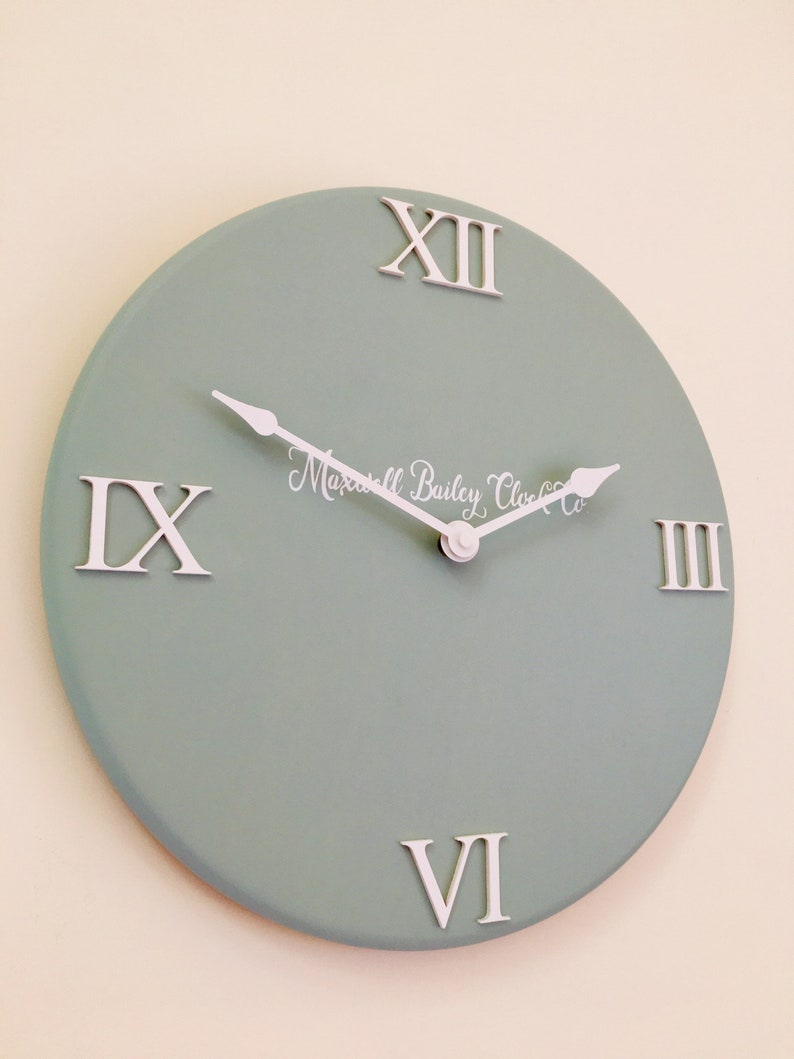 Sage green wall clock with raised roman numerals made with Etsy