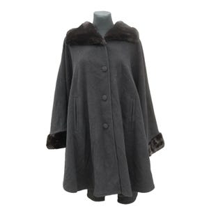 May include: A gray wool cape with a black faux fur collar and cuffs. The cape has a button closure and two pockets.