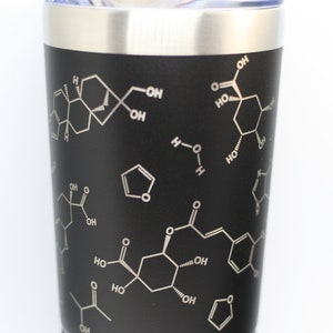 May include: A black stainless steel tumbler with a white design of chemical formulas. The tumbler has a silver lid and a silver bottom.
