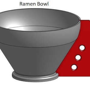 May include: A gray ceramic ramen bowl with a red base and three holes. The bowl is 4.75 inches tall. Ramen Bowl.
