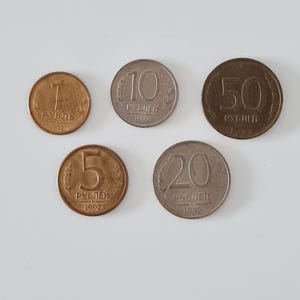 May include: Five Russian coins from 1992 are displayed. The coins are in various denominations: 1, 5, 10, 20, and 50 rubles. The coins are circular, with the denomination and year clearly visible.