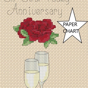 May include: A cross-stitch pattern for a ruby anniversary card. The design features two champagne glasses, two hearts, a red rose, and the text "On Your Ruby Anniversary 2024 Andrew and Amanda".