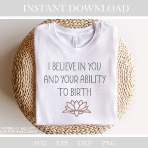 May include: White t-shirt with the text "I believe in you and your ability to birth" in gray and a pink lotus flower graphic.
