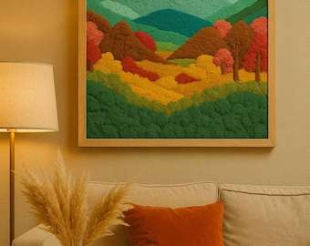 May include: A framed landscape art piece depicting a colorful mountain scene. The artwork features green, yellow, orange, and brown hues, with a light green sky. The frame is made of light-colored wood. The artwork is displayed above a beige sofa with an orange pillow.