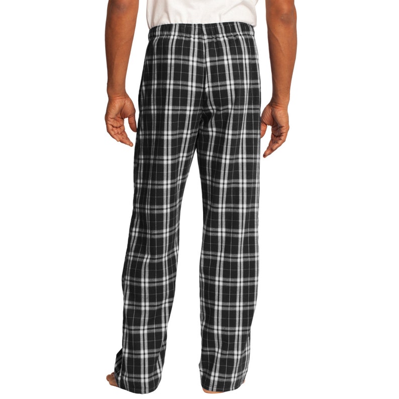 May include: Black and white plaid pajama pants with an elastic waistband.