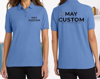 May include: A light blue polo shirt featuring a collar, a button placket, and short sleeves. The front displays the black text MAY CUSTOM Print . Embroidery . Design. The back features the same text and a logo with the letters MC.