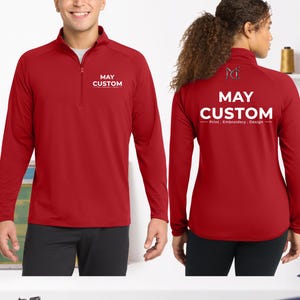 May include: A red long-sleeve quarter-zip pullover featuring the white text MAY CUSTOM on the front left chest. The back displays a logo with the letters MC and the white text MAY CUSTOM Print . Embroidery . Design centered on the upper back.