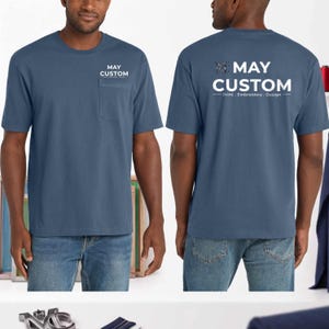 May include: A slate blue short-sleeve t-shirt with a chest pocket. The front features the white text MAY CUSTOM. The back displays a large white logo with the text MAY CUSTOM Print . Embroidery . Design and a stylized MC monogram graphic.