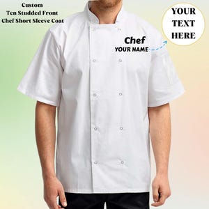 May include: A white chef's short-sleeve coat with a ten-studded front. The coat features a mandarin collar and a pocket on the left sleeve. The text "Chef YOUR NAME" is printed on the chest. The image also includes the text "Custom Ten Studded Front Chef Short Sleeve Coat".