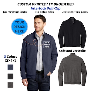 May include: A navy blue Interlock Full-Zip jacket with a custom design area. The image shows the jacket in navy, black, and gray. Text reads "Custom Printed/Embroidered" and "Soft and versatile."