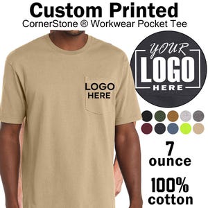 May include: A tan short-sleeve pocket t-shirt with the text "LOGO HERE" printed on the pocket. The image includes text stating "Custom Printed CornerStone Workwear Pocket Tee", "7 ounce", and "100% cotton", along with a color palette chart.