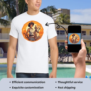 May include: White t-shirt featuring a circular graphic of a person and a tiger-like animal set against an orange sunset. The person is wearing a white tank top and blue pants. The animal has a blue collar. The image is on a smartphone.