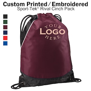 May include: Burgundy drawstring cinch pack with black trim and a white zipper. The bag has a black and white patterned bottom and a white drawstring. The bag has the text "YOUR LOGO HERE" printed in peach on the front.