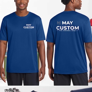 May include: A royal blue short-sleeved t-shirt featuring the white text MAY CUSTOM Print, Embroidery, Design on the front left chest and a larger version of the same logo and text printed across the center of the back of the garment.