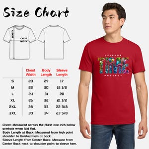 May include: A red t-shirt with the text "LEISURE PROJECT" in a colorful, artistic design. The image also includes a size chart with measurements in inches for chest width, body length, and sleeve length.