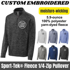 May include: A charcoal gray 1/4-zip pullover fleece with a moisture-wicking fabric. The fleece is 5.9 ounces and made of 100% polyester yarn-dyed fleece. The pullover has a mock neck and a zipper that goes up to the neck. The pullover has a small circle on the left chest with the text "YOUR LOGO HERE".