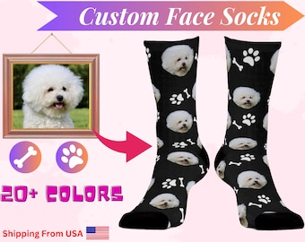 May include: Custom face socks with a white dog's face on a black background with white paw prints and bone designs.  The text "Custom Face Socks" is at the top of the image.  The text "20+ COLORS" is at the bottom of the image.