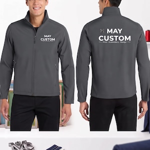 May include: A dark gray softshell jacket featuring a high collar and a full-length front zipper. The chest displays the white text MAY CUSTOM. The back of the jacket features the same logo with the text MAY CUSTOM Print Embroidery Design.
