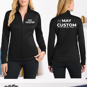 May include: A black long-sleeve zip-up jacket with a mock neck. The front left chest features the white text MAY CUSTOM Print . Embroidery . Design. The back displays the same white logo and text in a larger size, centered on the upper back.