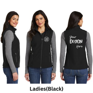 May include: A black softshell vest featuring a high collar, a full-length front zip, and two zipped side pockets. The front left chest displays a circular logo placeholder, while the back features the white text Your DESIGN Here.