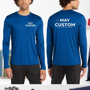May include: A royal blue long-sleeve shirt featuring the white text MAY CUSTOM Print . Embroidery . Design on the chest and a larger version of the same logo on the back. The shirt has a crew neckline and is paired with black pants.