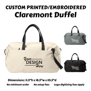 May include: A beige canvas duffel bag with black straps and a zippered pocket. The bag has a white graphic that says "Your Design Here". The bag is 11.5 inches high, 18.5 inches wide, and 10.5 inches deep.