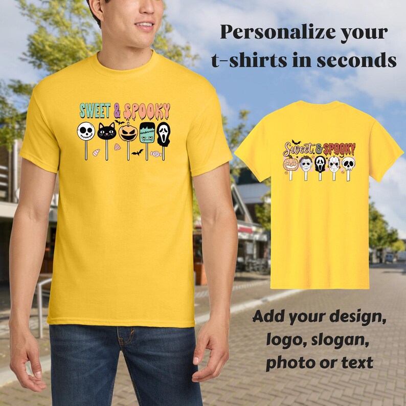 May include: A yellow t-shirt with the text "SWEET & SPOOKY" and Halloween-themed graphics. The design includes a skull, cat, pumpkin, Frankenstein's monster, and a ghost. The image also shows a smaller t-shirt with the same design.