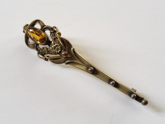 A torch brooch with topaz glass stone - image 1