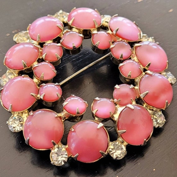 Pink moonglow and rhinestone brooch.