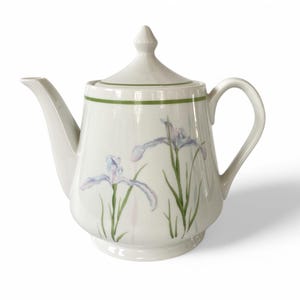 May include: White porcelain teapot with a green trim and a floral design of purple irises.