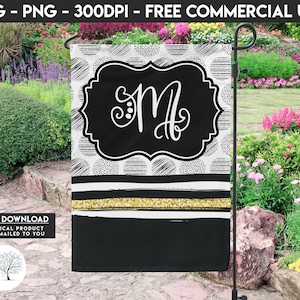 May include: A black and white garden flag with a white background and black polka dots. The flag features a black circle with a white border and the letter "M" in white script inside the circle. The flag has a gold glitter stripe and a black stripe at the bottom.
