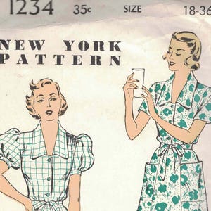 May include: Vintage sewing pattern showing two dress designs. One dress is a green and white checked pattern with puff sleeves and pockets. The other is a floral print dress with a collared neckline and a tie waist. The pattern is from New York Pattern.