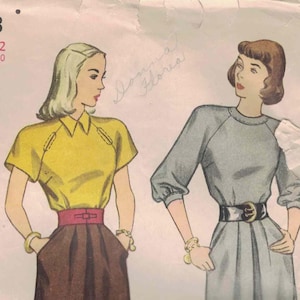May include: Vintage Simplicity pattern 1773 showing two women's fashion designs. One model wears a yellow collared top with a brown skirt and a red belt. The other model wears a grey dress with a black belt. The pattern is size 12, bust 76 cm.