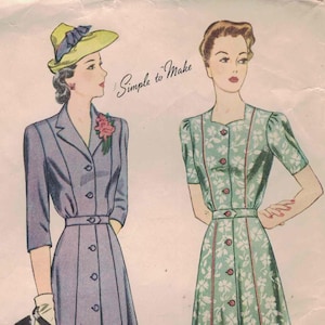 May include: Vintage Simplicity pattern 4596 featuring two dress designs. One dress is a button-down style in a lavender color, and the other is a floral print dress in green. The text "Simple to Make" is visible.