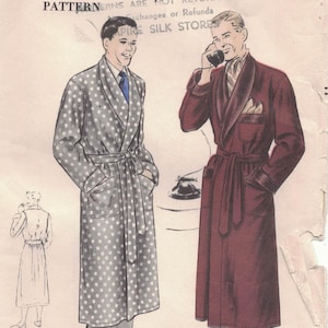 May include: Vintage Vogue pattern envelope featuring illustrations of two men in robes. One robe is gray with white polka dots, the other is burgundy. The envelope has text that reads "Vogue Pattern Service".