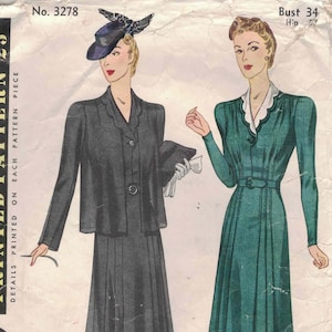 May include: Vintage Simplicity sewing pattern featuring two women's fashion designs. One woman wears a dark gray suit with a jacket, skirt, and hat. The other model is in a green dress with a white collar. The pattern is marked "No. 3278".