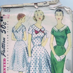 May include: Vintage Simplicity sewing pattern for a dress, size 18, bust 36. The pattern shows two women wearing dresses, one in a white and blue polka dot print and the other in a solid green. The pattern is titled "Simplicity Printed Pattern 50c".