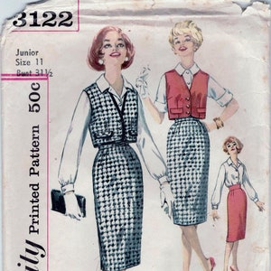 May include: A vintage sewing pattern for a skirt and vest set. The pattern is for a junior size 11 with a bust measurement of 31 1/2 inches. The pattern is printed on a white background with pink and black text. The pattern includes instructions for making a skirt and vest set. The pattern is from Simplicity and is number 3122.
