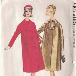 May include: A vintage McCall's printed pattern envelope for a misses' coat. The illustration features two coat styles: a bright red coat with a round collar and buttons, and a gold coat with a high neck tie detail. Text includes McCall's, Printed Pattern, and Misses' Coat.
